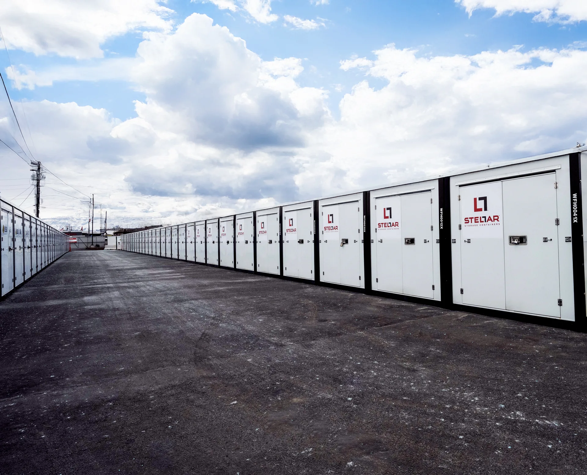 Rows of Stellar storage containers along a gravel driveway